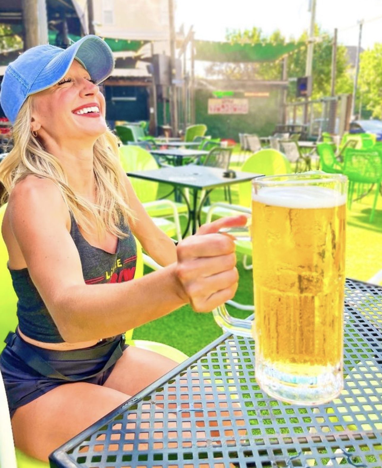 blonde woman holding a giant beer mug